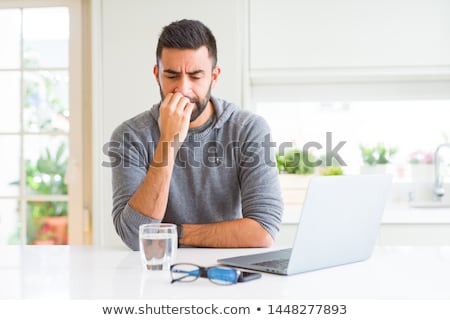 Foto stock: Embarrassed Young Man Looking At Smartphone