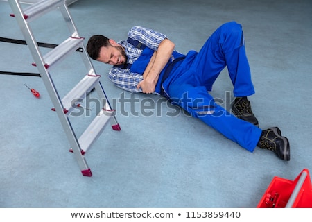 Stock fotó: Handyman Lying On Staircase