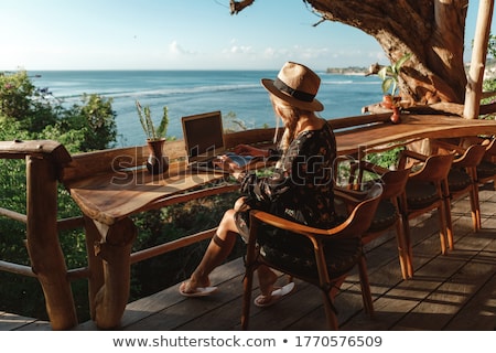 Stock photo: Happy Young Woman Using Laptop Outdoors