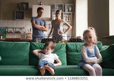 Foto stock: Little Girl Upset By Parents Arguing