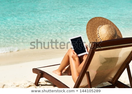 Сток-фото: Woman Relaxing On Sunbed With Tablet