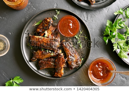 Foto stock: Roasted Lamb Ribs With Spices And Vegetables On Black Plate On D