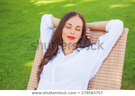 [[stock_photo]]: Elle · fille · russe · allongée · sur · une · chaise