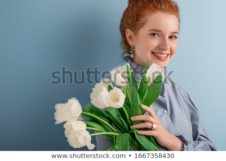 Foto stock: Close Up Portrait Of A Redheaded Woman Holding Tulip Flowers