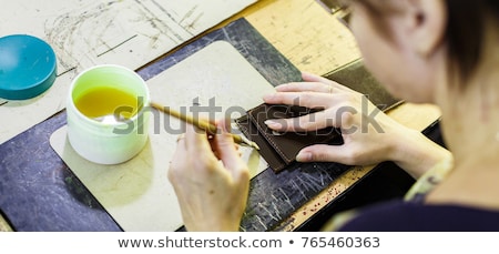 Stock fotó: Woman Smearing With Glue A Part Of A Wallet