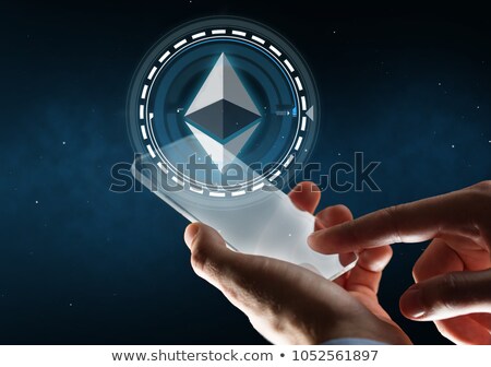 Сток-фото: Hand With Smartphone And Ethereum Hologram