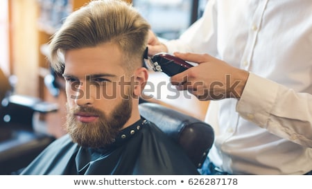 Stok fotoğraf: Man And Barber Cutting Hair At Barbershop