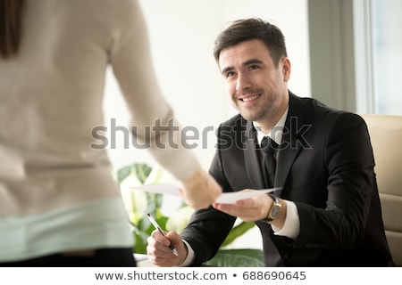 Foto d'archivio: Man Giving Financial Papers To Colleague