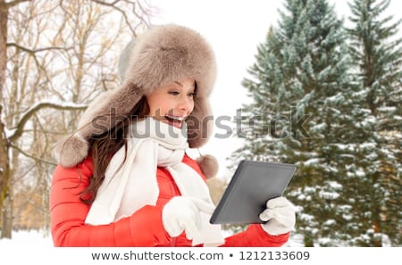 ストックフォト: Woman In Fur Hat With Tablet Pc Over Winter Forest