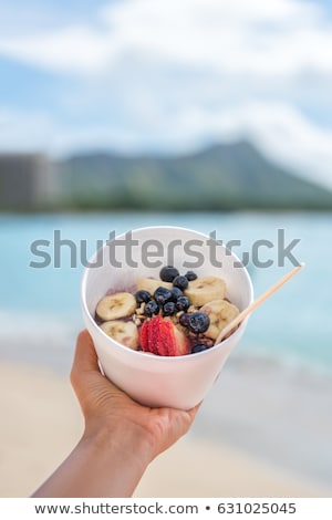 Сток-фото: Woman Holding Bowl With Strawberries On Beach