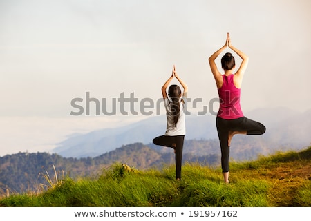 [[stock_photo]]: Mother And Daughter Doing Exercises Together