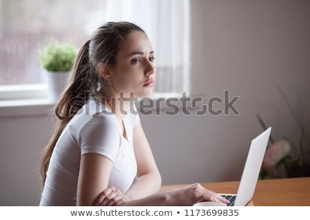 ストックフォト: Thoughtful Young Woman Sitting Alone At Desk