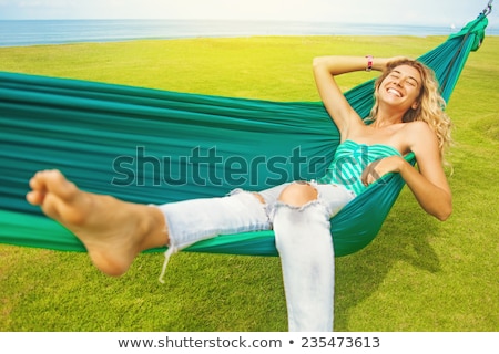 Foto stock: Young Blonde Woman In A Hammock