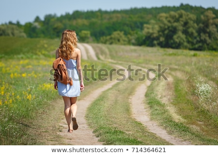 Stockfoto: Beautiful Woman Wearing Blue Dress On A Field