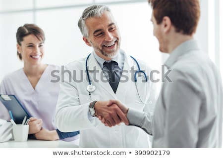 Foto stock: Doctor Shaking Hand With Patient
