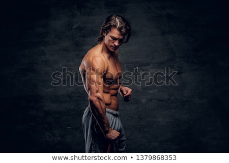 ストックフォト: Attractive Musculous Guy Lifting Weight