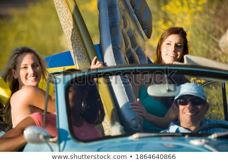 Stockfoto: Four People Sitting On Surfboards