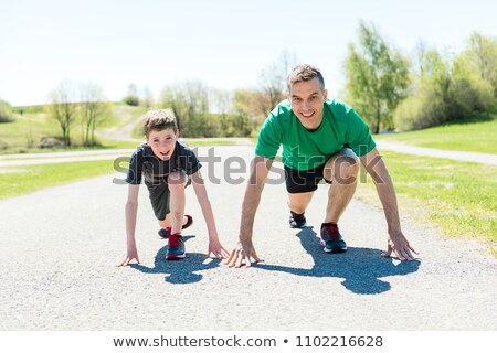 Foto stock: Father And Son Running In A Field