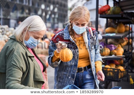 Stockfoto: Senior Woman Buying Gourd On Market