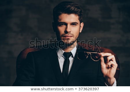 ストックフォト: Portrait Of Man In Leather Jacket Holding Chair While Sitting