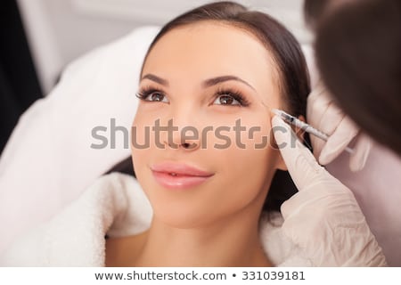 Stock foto: Smiling Woman Gets Eyebrow Treatment