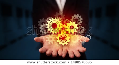 Foto stock: Holding Gears In His Hand