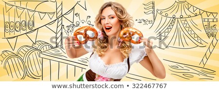 Foto stock: Two Bavarian Women Eating Pretzels And Holding Beer