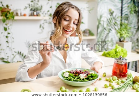 Foto stock: Young Woman Eating Fruit Salad