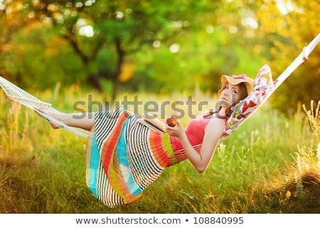 Stok fotoğraf: Young Woman In Dress Sitting On The Grass