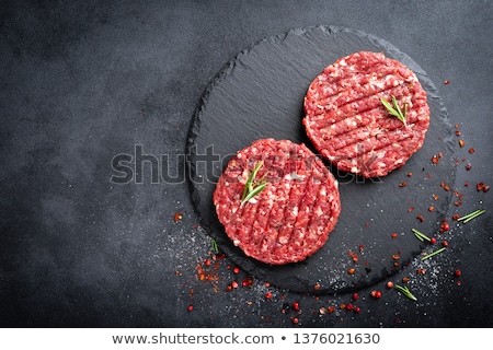 Foto stock: Fresh Raw Butchers Lamb Beef Cutlets On Chopping Board With Vintage Meat Hatchet And Hammer On Woode