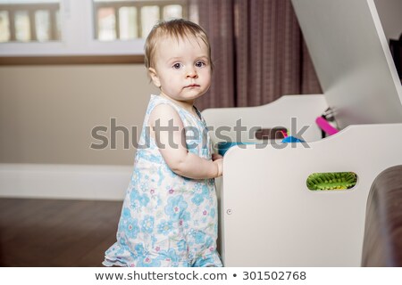 Stock fotó: Small Beautiful Baby Girl On The Front Of His Toy Box