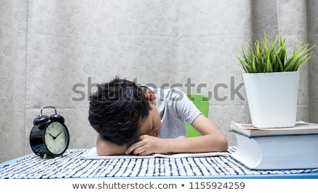 [[stock_photo]]: Tired Student Boy Sleeping On Table At Home