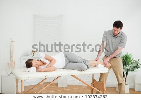 Foto d'archivio: Foot Being Stretched By A Physiotherapist In A Room