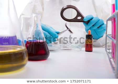 Stok fotoğraf: Forensic Scientist With Evidence Tube