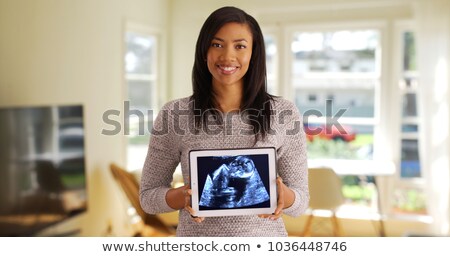 Stok fotoğraf: Pregnant Cheerful Woman Showing Ultrasound Scans