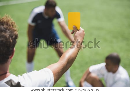 Stock photo: Referee On Football Field Showing Yellow Card