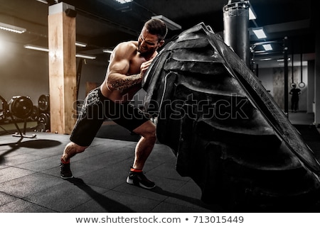 Сток-фото: Shirtless Man Holding Heavy Weight