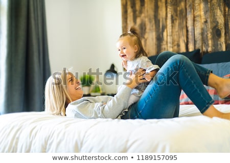Сток-фото: Mother And His Baby Daughter On Bed Having Fun