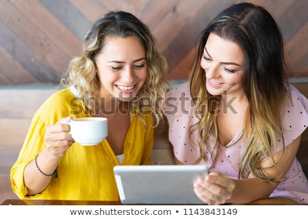 ストックフォト: Happy Young Female Student Having Cup Of Cappuccino In Front Of Laptop In Cafe