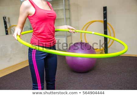 Stockfoto: Woman Doing Exercises With Hula Hoop