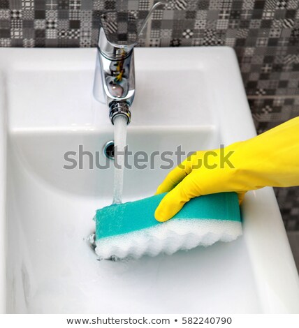 Foto stock: Hand In Yelow Glove With Sponge