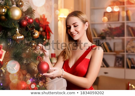 Stockfoto: Young Pretty Happy Smiling Blond Woman On Christmas In Santas Red Hat And Holiday Decorated Plaid L