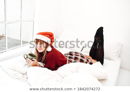 [[stock_photo]]: Young Pretty Brunette Girl Laying In Cozy Bed With Coffee Wearing Wool Winter Sweater Happy Smiling