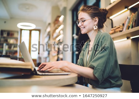 [[stock_photo]]: Laptop With With Screen Against Library Shelf