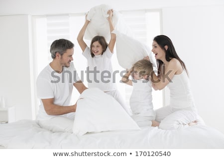 Сток-фото: Family With Child Having Fun On Bed With Pillow Fight