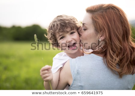Foto stock: Cute Kid Boy With His Mother On A Summer Meadow