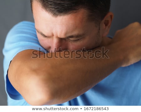 [[stock_photo]]: How To Sneeze Correctly Man Sneezes On The Elbow Concept Of The Spread Of The Virus