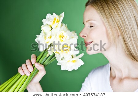 [[stock_photo]]: Close Up Shot Of Blonde Eyes Shut Smelling Bunch Of Flowers