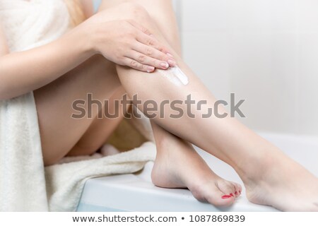 Foto stock: Pretty Young Woman Using Body Milk