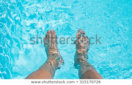 Stock fotó: Mans Feet With Bright Blue Swimming Pool Background